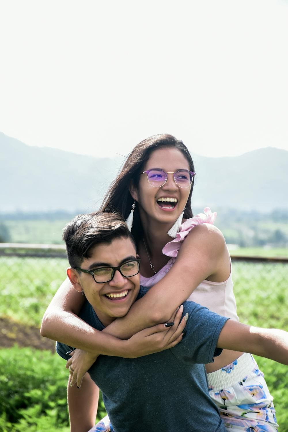 A young couple laughing together outdoors